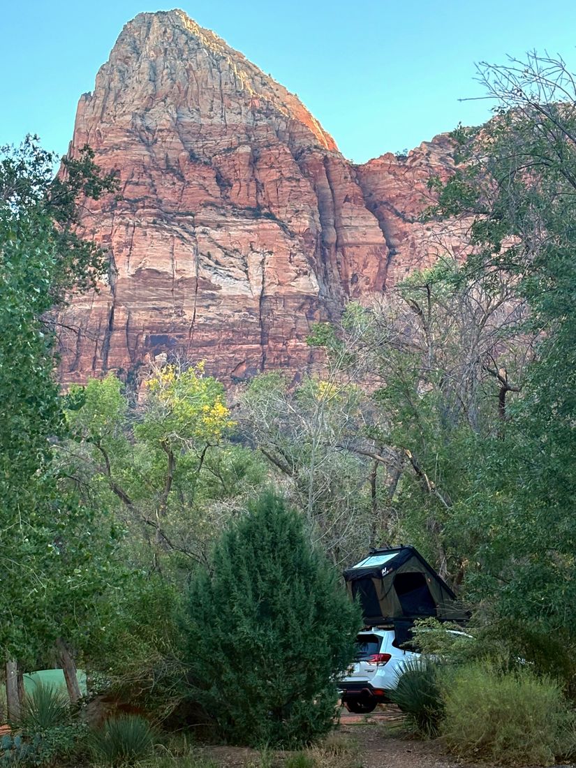 Rooftop tent camp below a red rock peak in Zion