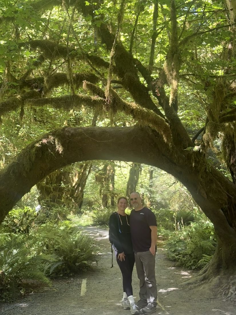 Jesse and Becky under a mossy tree arch